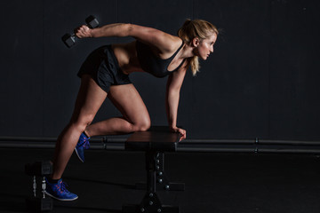 Fototapeta na wymiar woman fitness workout - holding dumbbells