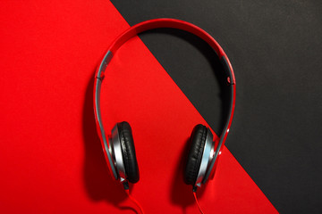 new red headphones with black pads on the black and red background