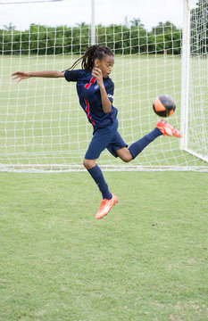 Soccer player practicing rainbow flick on field