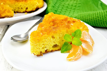 Pie mandarin with mint and spoon on light board