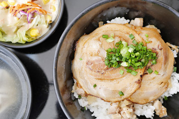 japanese rice bowl topped with sliced roasted pork