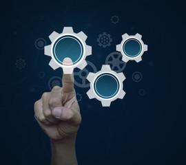 Man hand pressing gear icon with copy space over blue background