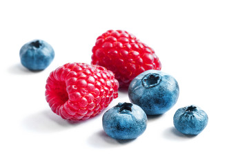 Blueberries and raspberries on white background. Close up, top view, high resolution product. Harvest Concept