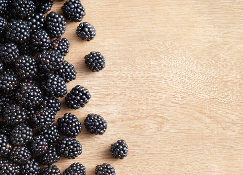 Blackberries on wooden background. Close up, top view, high resolution product. Harvest Concept