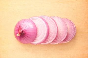 Sliced onion on wooden cutting board