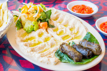 Plate of humus, salad and sauces