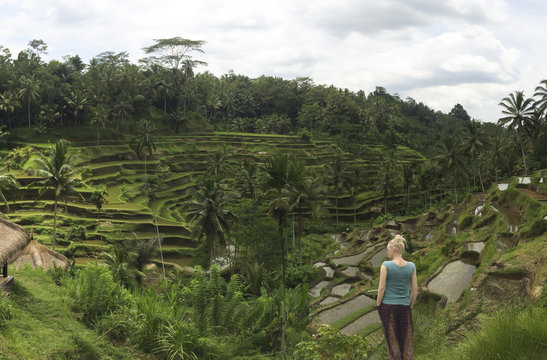 Caucasian tourist admiring rural rice terrace