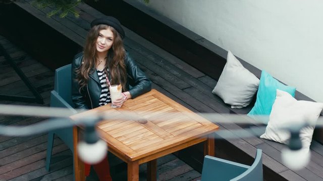 Young attractive Caucasian sending an air kiss. 4K cinemagraph - motion photo seamless loop
