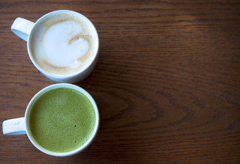 Top view of two cups of hot coffee on wooden table