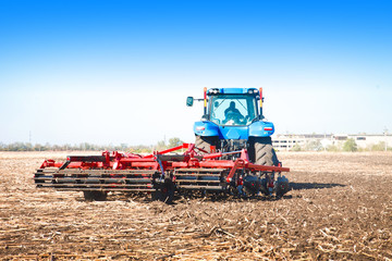 Fototapeta premium Tractor working in a field