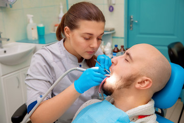 beautiful Man having teeth examined at dentists