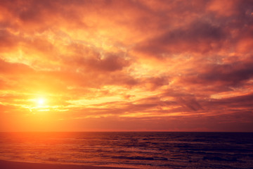 Naklejka na ściany i meble Red bright sunset over sea