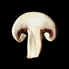 sliced piece of champignon mushroom isolated on black