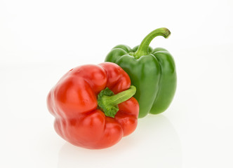 Fresh red and green bell peppers, isolated on white background.