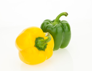 Fresh yellow and green bell peppers, isolated on white background.