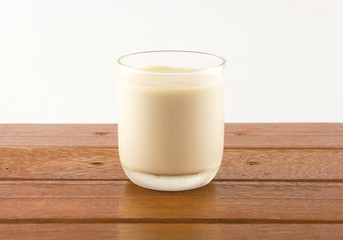 A grass of milk on wooden table 
