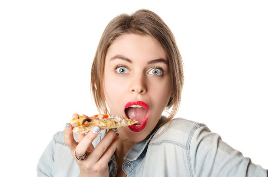 Pretty young sexy woman eating big slice of pizza with big opened mouth standing on white background