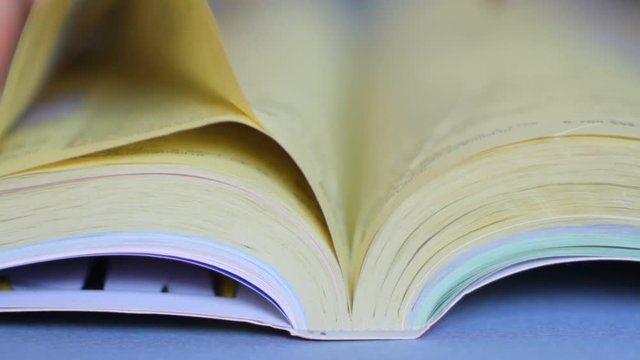 Man looking for a telephone number in the directory