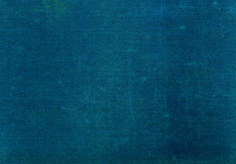 Grungy dark green textile surface with scratches.