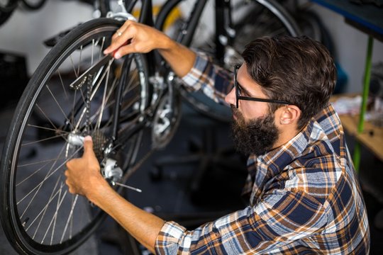 Bike mechanic checking at bicycle