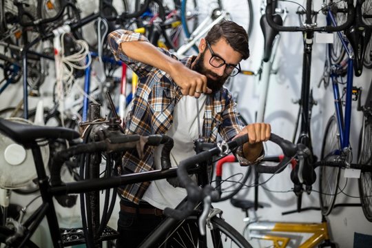 Bike mechanic checking at bicycle