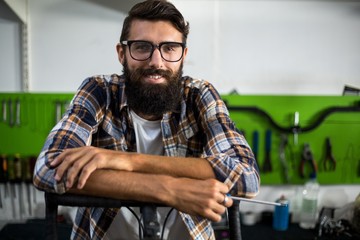 Bike mechanic leaning on a bike