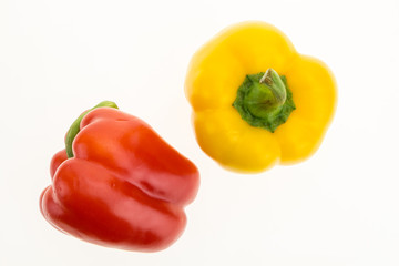 Fresh red and yellow bell peppers, isolated on white background.