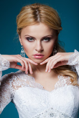 beautiful bride in wedding dress on blue