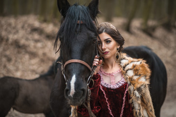 Princess with her horse in the woods © stelmaht