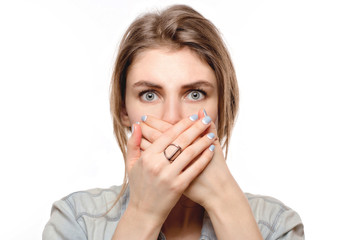blue-eye woman covers her mouth with her hands