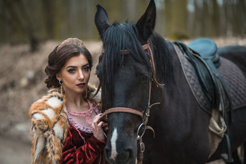 Obraz premium Princess with her horse in the woods