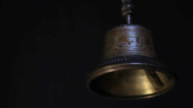 bronze bell on black background