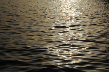 sea water at sunset with dark waves background