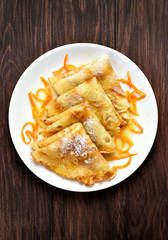 Pancakes with orange sauce, top view