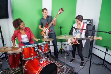 Band Members Performing In Recording Studio