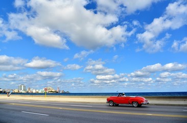 Havana - seafront and red oldtimer. Havana's promenade, in Havana,Cuba. Havana and americam car, sea.
