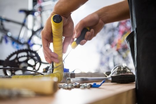 Close-up of worker repairing bicycles