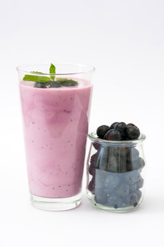 Fresh blueberry smoothie on white background
