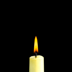 candle burning brightly in the black background