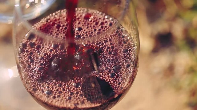 Red wine poured into glass.