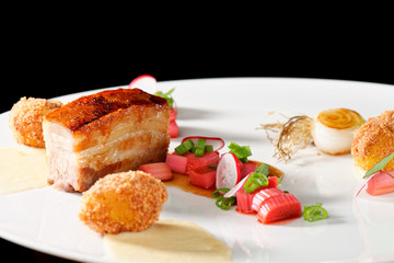 Plated freshly grilled pork bellies with rhubarb vegetable