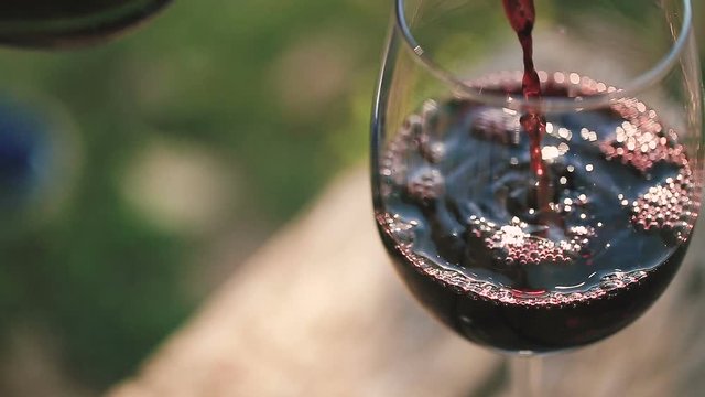 Red wine poured into glass.