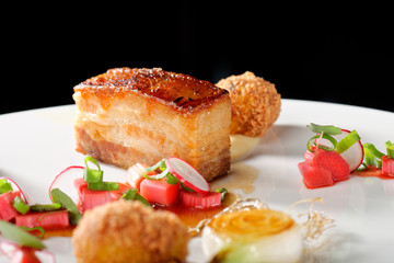 Plated freshly grilled pork bellies with rhubarb vegetable