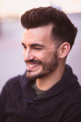 Obraz premium Portrait of a smiling young man in the city