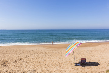 Fototapeta na wymiar Beach Ocean Umbrella Swimmer