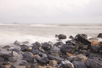 Fototapeta na wymiar landscape of cloudy sky and sea which have breakwater on windy day ; Songkhla Thailand (slow shutter speeds)