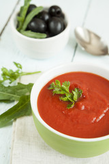 Colorful tomato soup on a white background, closeup