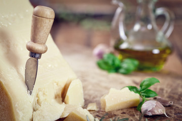 Fototapeta na wymiar Italian Parmesan Cheese with Basil Leaves