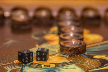 two dice and chips on the backgammon table
