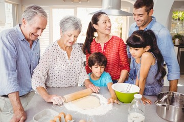 Senior woman preparing food with family